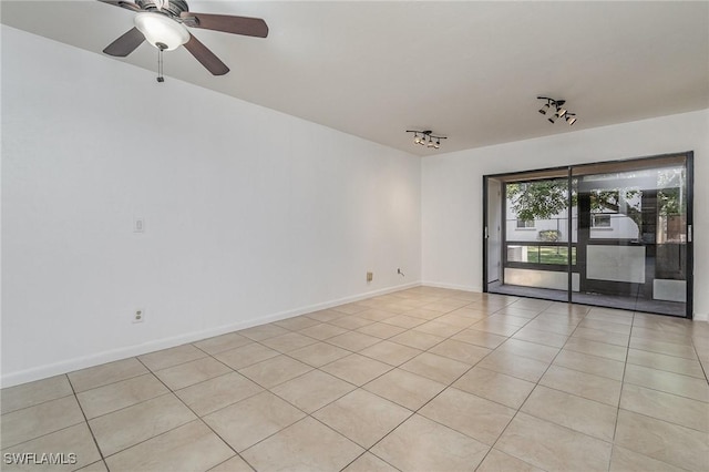 tiled empty room with rail lighting and ceiling fan