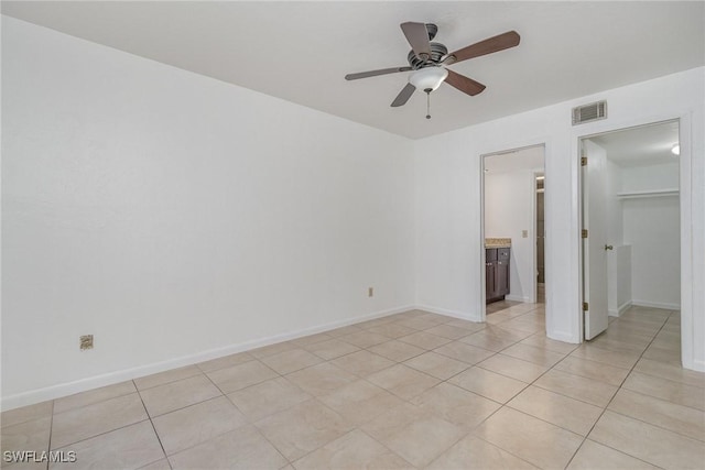 unfurnished room featuring ceiling fan and light tile patterned floors