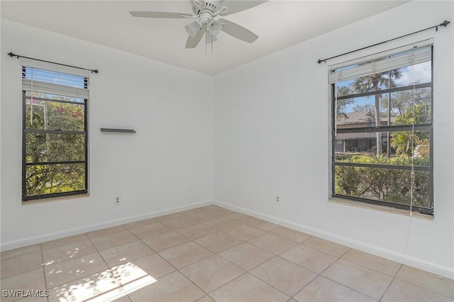 tiled empty room featuring ceiling fan