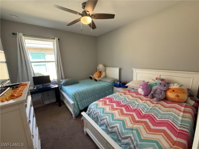 bedroom with ceiling fan and dark carpet