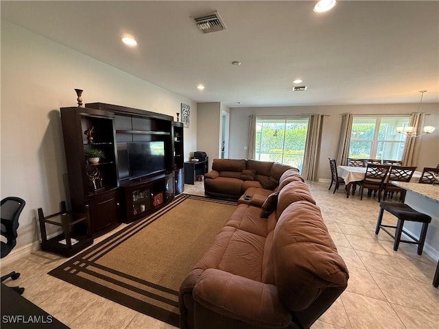 tiled living room featuring a chandelier