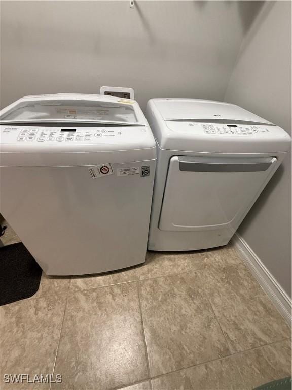 washroom with washing machine and clothes dryer