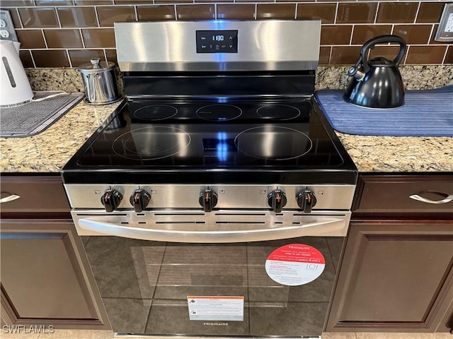 details featuring light stone counters, decorative backsplash, dark brown cabinetry, and stainless steel electric range