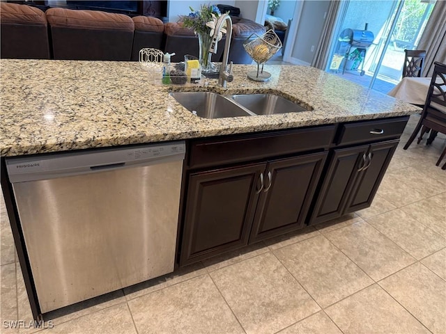 kitchen featuring dishwasher, sink, light tile patterned floors, dark brown cabinetry, and light stone countertops