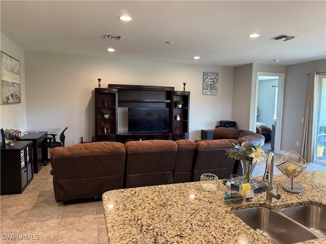 tiled living room featuring sink