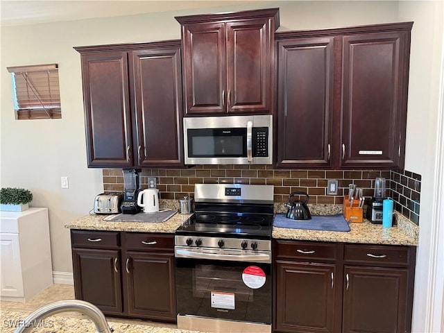 kitchen with stainless steel appliances and decorative backsplash