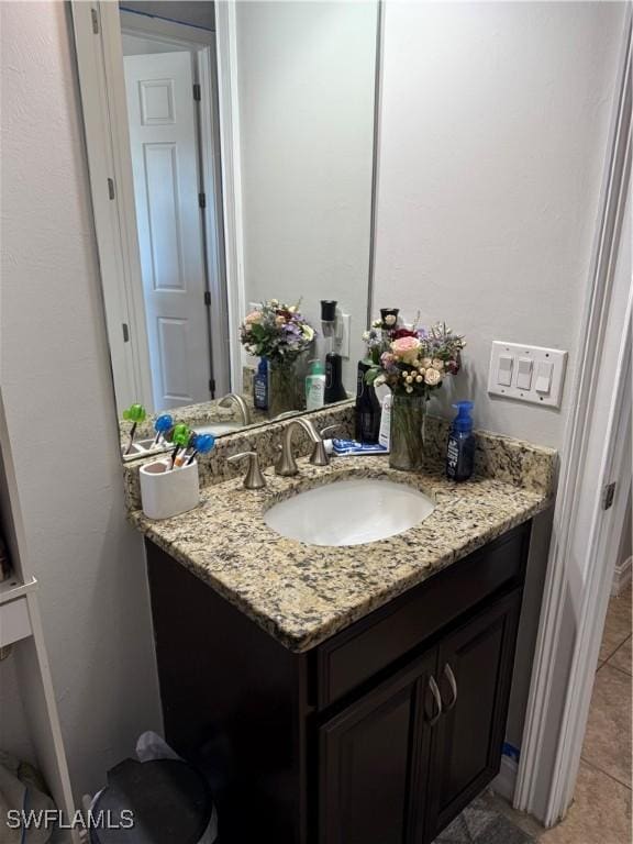 bathroom with tile patterned flooring and vanity