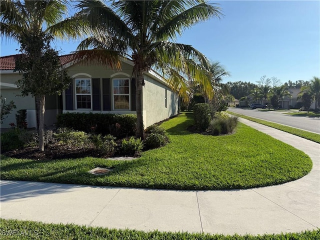 view of side of home featuring a yard