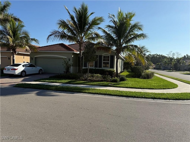 view of front of house with a garage and a front yard