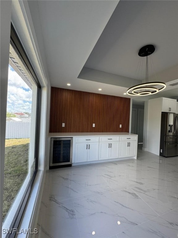 unfurnished living room featuring wood walls