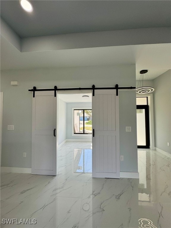 spare room with a barn door