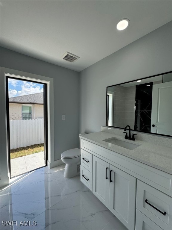 bathroom with vanity and toilet