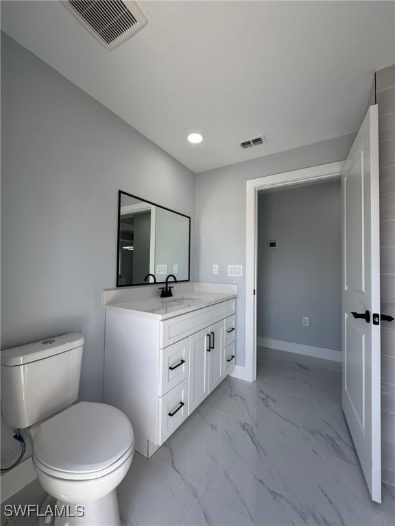 bathroom featuring vanity and toilet