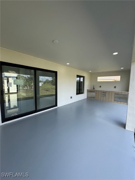 unfurnished living room with concrete flooring