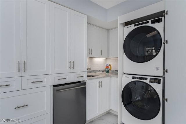 washroom featuring stacked washing maching and dryer