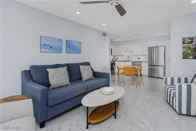 living room featuring sink and ceiling fan