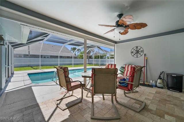 view of patio / terrace with ceiling fan, a lanai, and a fenced in pool