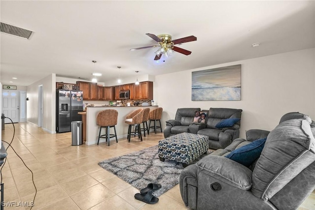 living room with ceiling fan and light tile patterned floors