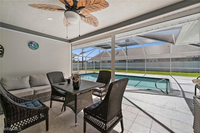 interior space featuring ceiling fan, a lanai, outdoor lounge area, and a fenced in pool