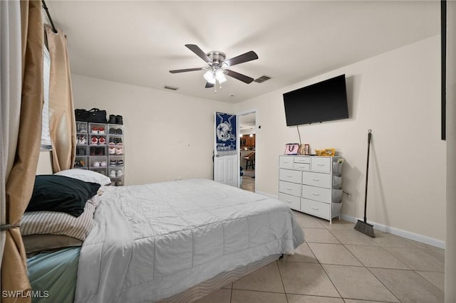 bedroom with ceiling fan and light tile patterned floors