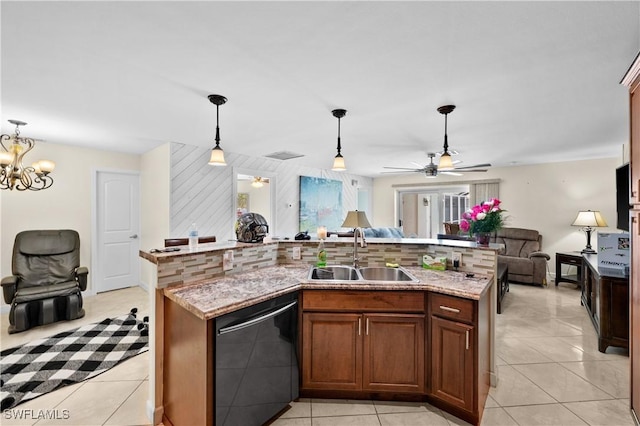 kitchen featuring tasteful backsplash, decorative light fixtures, light tile patterned floors, sink, and black dishwasher