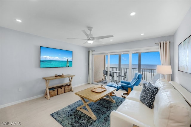 living room featuring ceiling fan and light hardwood / wood-style flooring