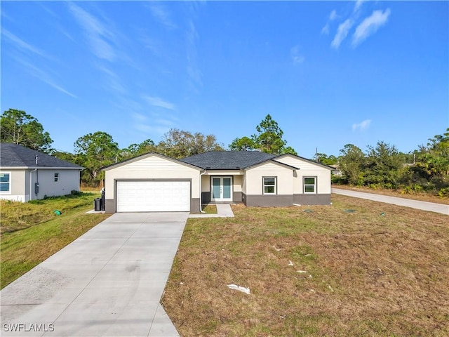 single story home featuring a garage and a front yard