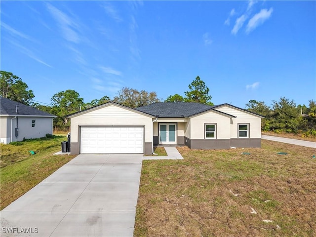 single story home featuring a garage and a front yard