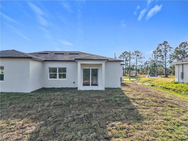 rear view of house with a lawn