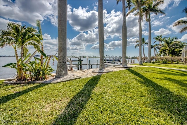 view of yard with a dock and a water view