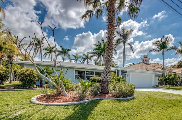 view of front of house with a garage and a front lawn