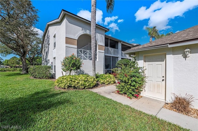 view of home's exterior with a lawn and stucco siding