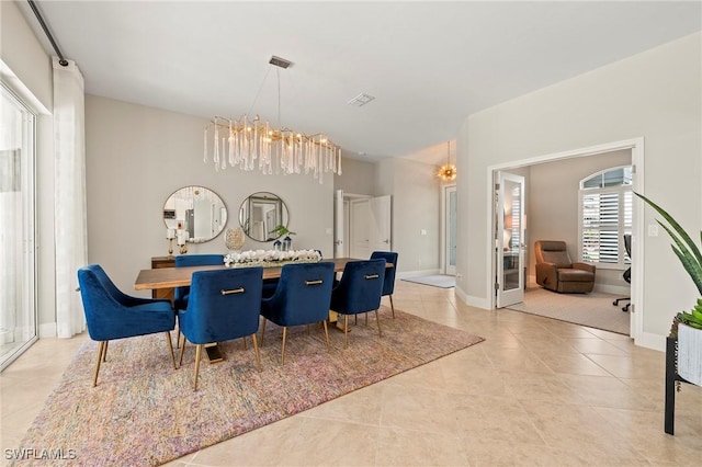 dining room featuring an inviting chandelier and light tile patterned floors