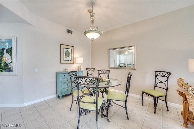 dining space with baseboards, visible vents, and light tile patterned flooring