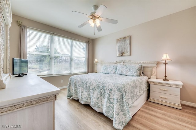 bedroom featuring light wood-style floors, baseboards, and a ceiling fan