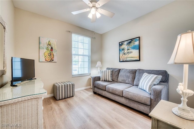 living area with ceiling fan, wood finished floors, and baseboards