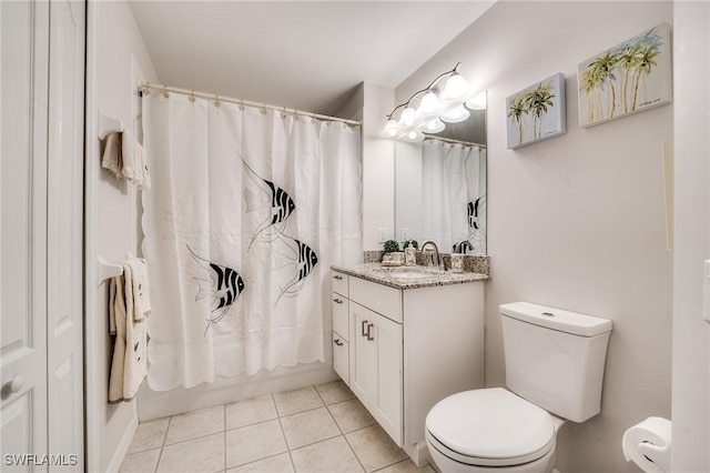 bathroom with tile patterned flooring, vanity, and toilet