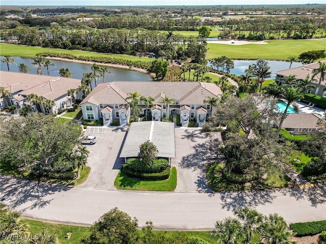 bird's eye view featuring golf course view, a water view, and a residential view