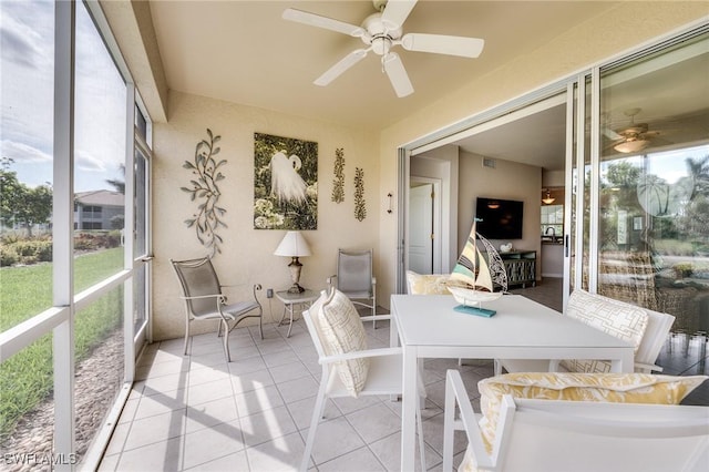 sunroom / solarium featuring ceiling fan