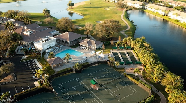 drone / aerial view with a water view and golf course view