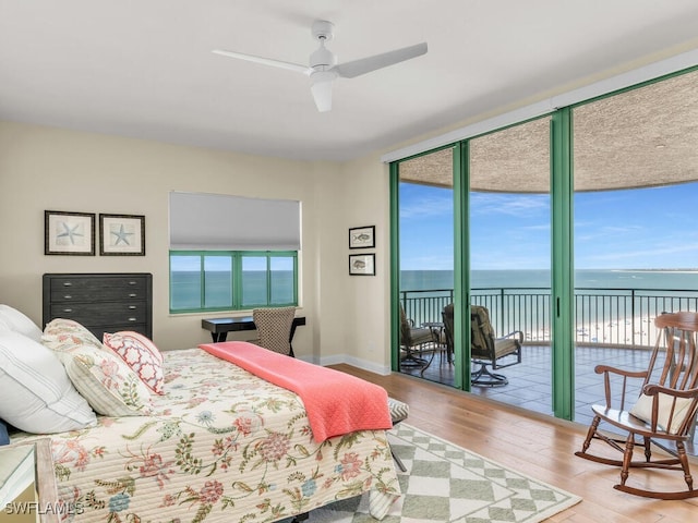 930 Cape Marco Dr Unit 806, Marco Island, FL 34145 - bedroom with hardwood / wood-style floors, a water view, access to outside, and a wall of windows