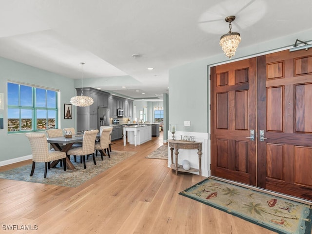 930 Cape Marco Dr Unit 806, Marco Island, FL 34145 - entrance foyer with a notable chandelier, plenty of natural light, and light wood-type flooring