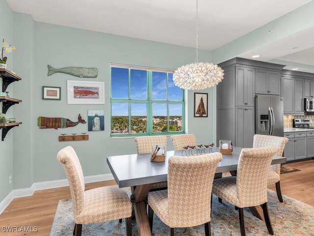 930 Cape Marco Dr Unit 806, Marco Island, FL 34145 - dining space with light hardwood / wood-style flooring and a chandelier