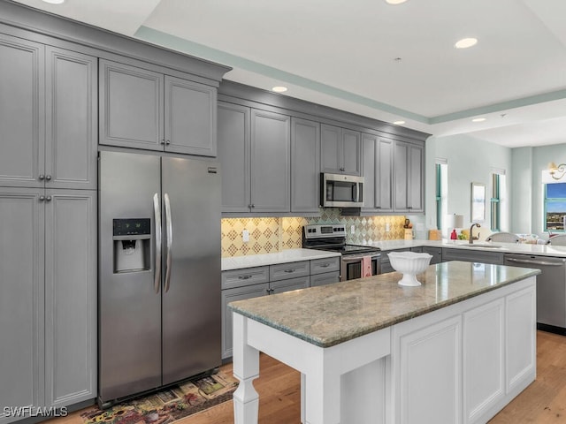 930 Cape Marco Dr Unit 806, Marco Island, FL 34145 - kitchen featuring light stone countertops, appliances with stainless steel finishes, gray cabinetry, and backsplash