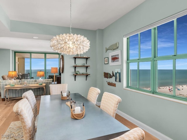 930 Cape Marco Dr Unit 806, Marco Island, FL 34145 - dining area featuring a water view, a notable chandelier, and light wood-type flooring