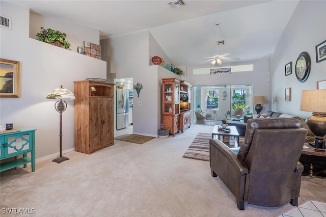 carpeted living room featuring ceiling fan and high vaulted ceiling