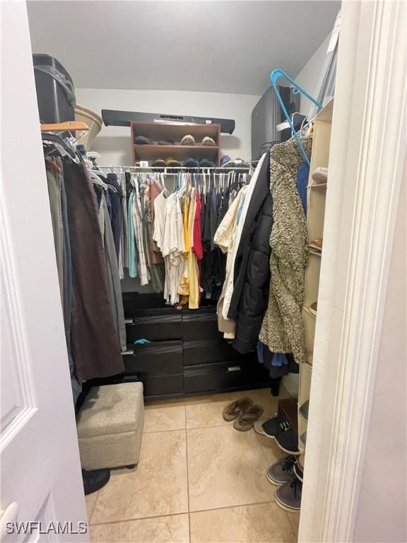 walk in closet with light tile patterned floors