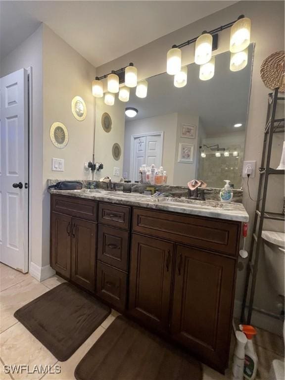 bathroom featuring vanity, tile patterned floors, and a shower