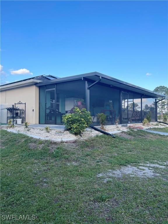 rear view of house with a lawn