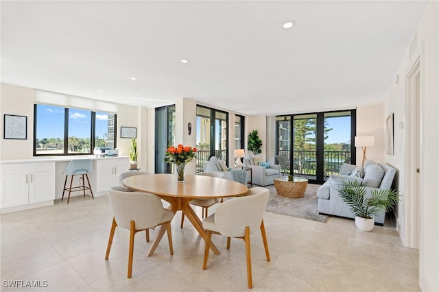 dining room with light tile patterned flooring and recessed lighting